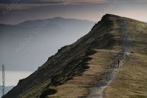 A Hiker walks along the path on Blencathra a fell in the English Lake District.