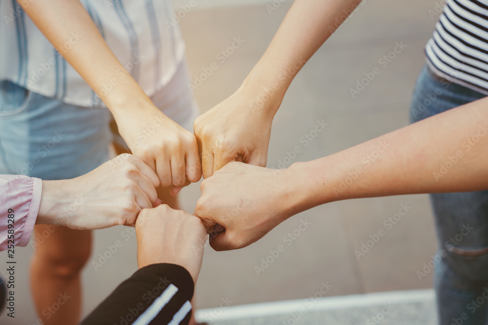 Close up at the hands many teenage girls. Show unity as a collaborative work together. To succeed, one has to understand each other in communication. Concept International Women's Day Close up at the hands many teenage girls. Show unity as a collaborative work together. To succeed, one has to understand each other in communication. Concept International Women's Day