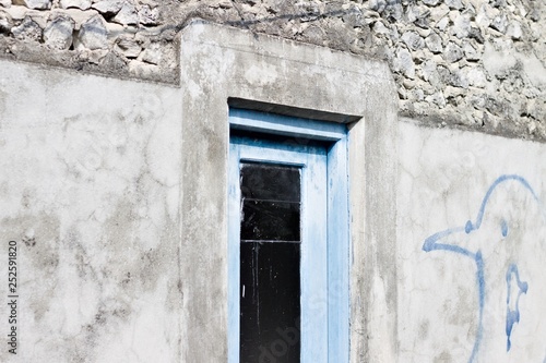 Blue wooden door with a black glass of a maldivian house (Ari Atoll, Maldives) © Tommaso