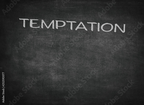 Temptation concept word on a chalkboard background
