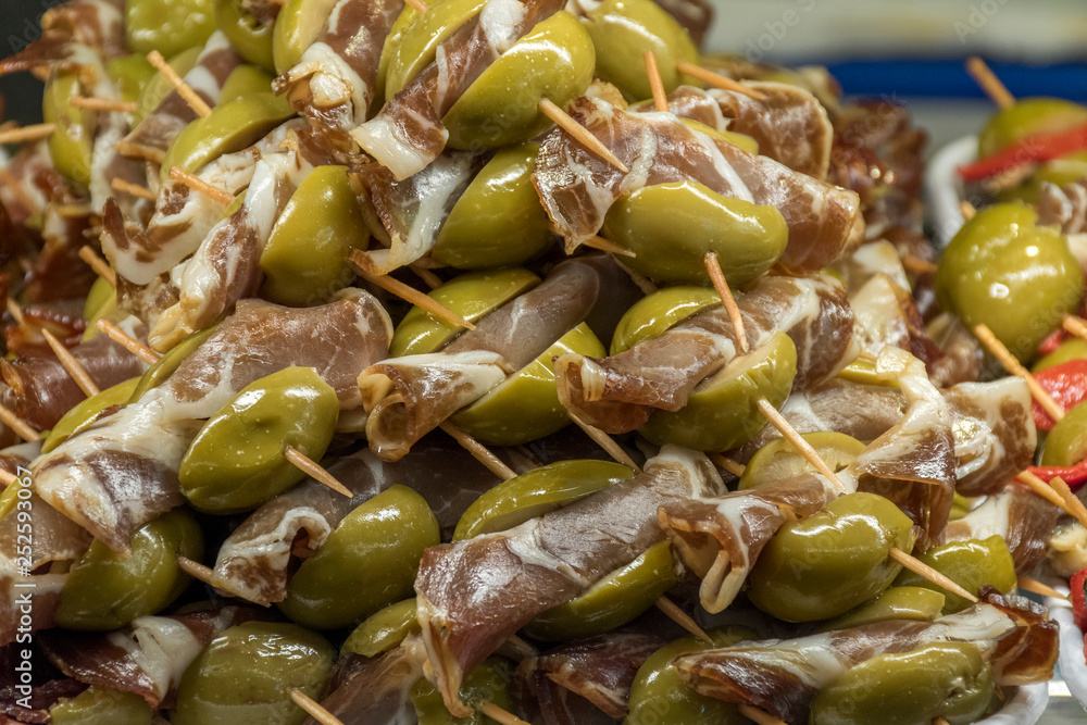 Close up, skewer of olives with garnish Close up, skewer of olives with garnish