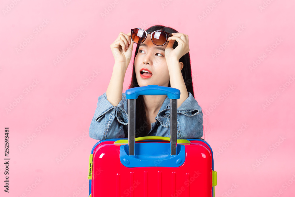 Traveler tourist woman in summer casual clothes.Asian Smiling woman wearing sun glasses.Passenger traveling abroad to travel on pink background. Traveler tourist woman in summer casual clothes.Asian Smiling woman wearing sun glasses.Passenger traveling abroad to travel on pink background.
