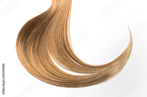 Piece of beautiful, shiny blonde hair on white isolated background