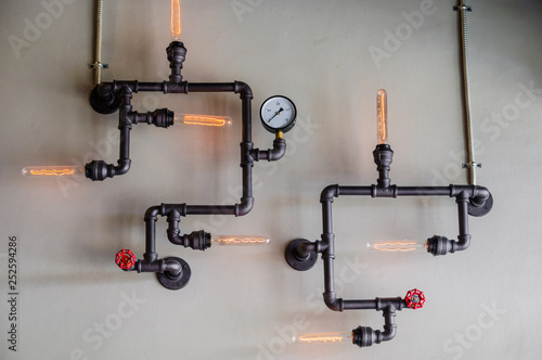 steel pipe and lamp on wall