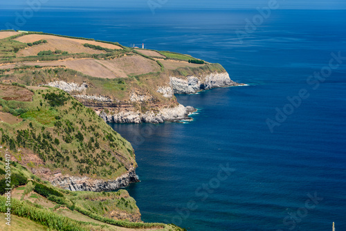 cliff and ocean in azores, view of the coast in soa miguel island during summer, azores, portugal photo