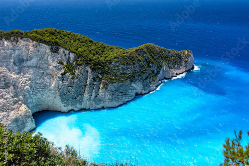 High angle view of blue sea and rocks, at Navagio Beach. Summertime at Zakynthos Island, Greece.