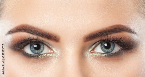 Beautiful woman with long eyelashes and with beautiful smoky eyes make-up. Eyes close up. Looking at the camera