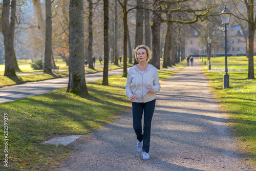 Slika na platnu Attractive mature woman taking her daily jog