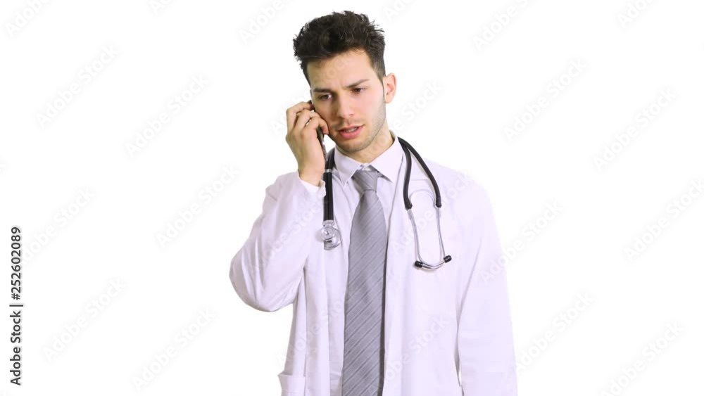 Handsome man doctor isolated on white background talking on smartphone, smiling positively Handsome man doctor isolated on white background talking on smartphone, smiling positively