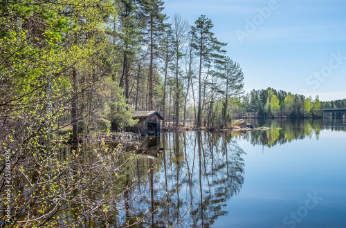 Spring landscape with old and broken boat deck at sunny day in Finland