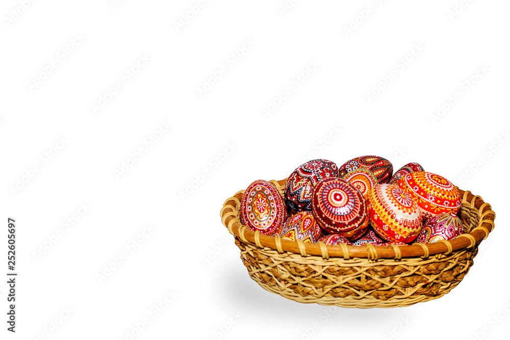Wooden Easter eggs in a wicker basket, hand-painted with acrylic paints, isolated on a white background. Wooden Easter eggs in a wicker basket, hand-painted with acrylic paints, isolated on a white background.