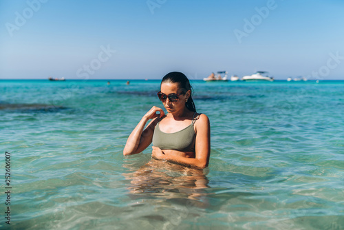 Pretty pan asian girl relaxing in blue sea water.