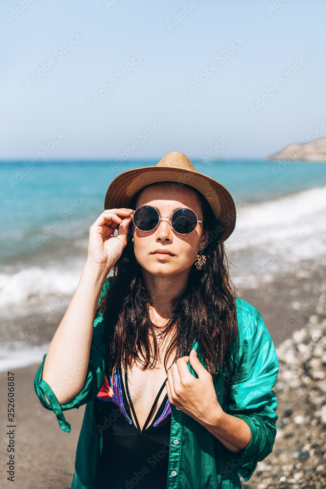 Pretty pan asian travel girl relaxing on the beach at the sea in green pareo. Pretty pan asian travel girl relaxing on the beach at the sea in green pareo.