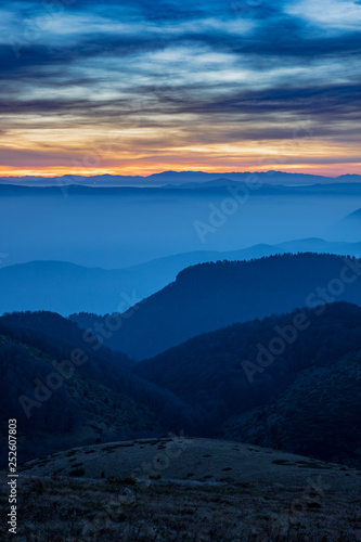 Layers of Mountain Ridges with fog at sunset © Mincho Minchev