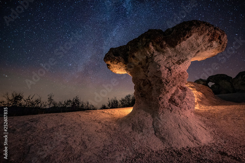 Mushroom rocks phenomenon under the night sky with Milky Way