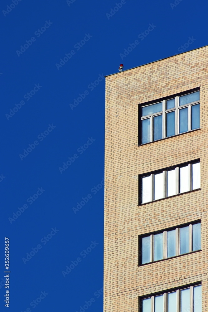 Modern brick office building on a background of clear blue sky. Modern brick office building on a background of clear blue sky.