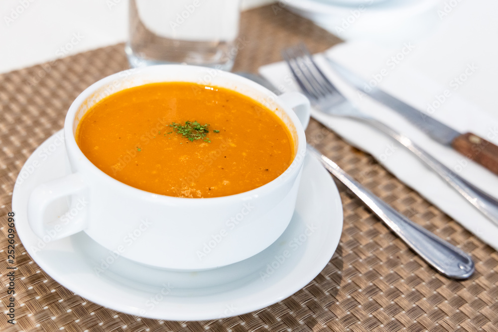 Serving of creamy tomato soup at restaurant Serving of creamy tomato soup at restaurant