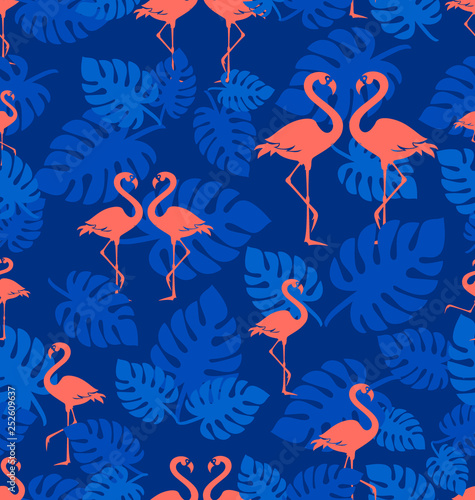 Tropical flamingo pattern. Coral flamingo. A flock of tropical birds with leaves of a tropical plant. Seamless pattern. Park of birds. Exotic birds on a dark blue background.