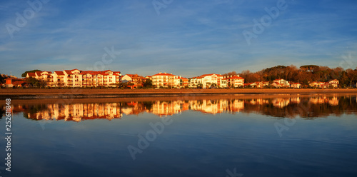 houses reflected in the water of the beach at sunset, Hendaia, France