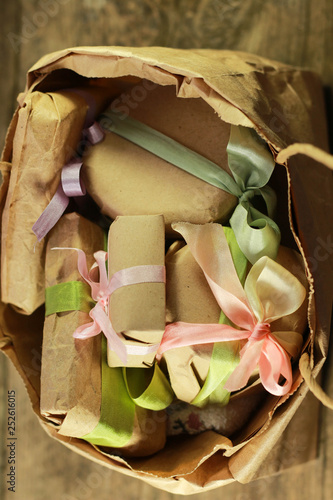 small paper bag with present boxes and flowers