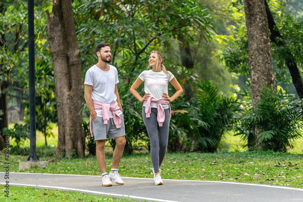 Man and Woman walking in the public park Man and Woman walking in the public park