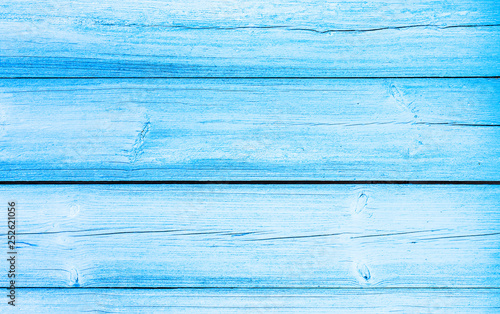 Old weathered wooden plank painted in blue color. Light blue plank texture of wood table. Backdrop for design art work.