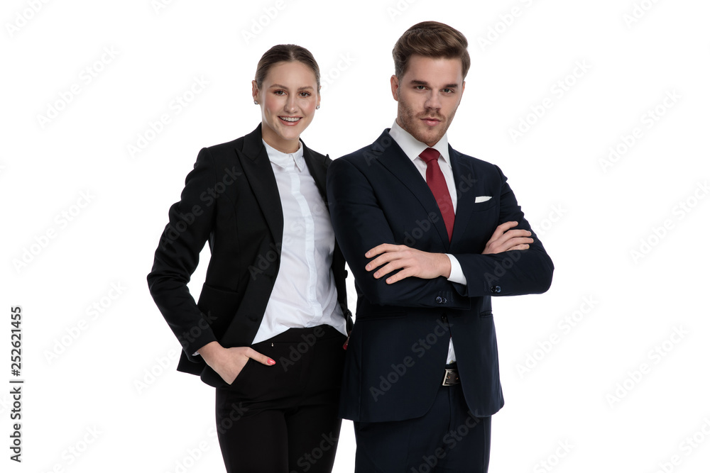 couple in business suits standing together with arms crossed couple in business suits standing together with arms crossed