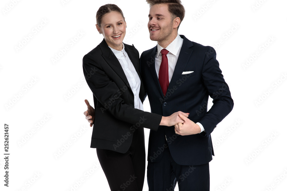 couple in business suits holding hands together couple in business suits holding hands together