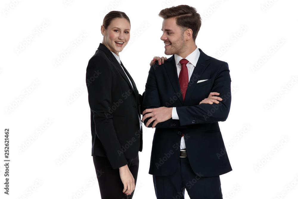 couple in business suits standing together with arms crossed couple in business suits standing together with arms crossed