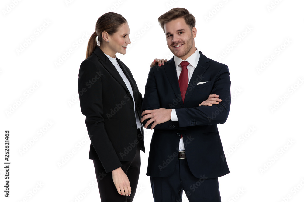 couple in business suits standing together with arms crossed couple in business suits standing together with arms crossed