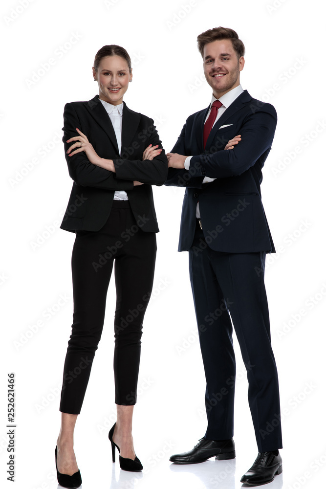 couple in business suits standing together with arms crossed couple in business suits standing together with arms crossed