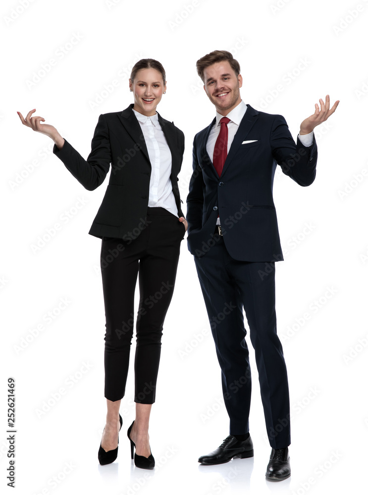 couple in business suits welcome with hands gesture couple in business suits welcome with hands gesture