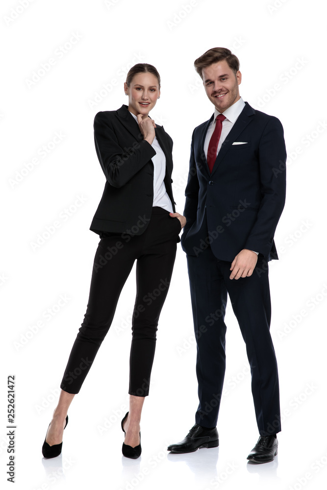 couple in business suits holding hands at chin thinking couple in business suits holding hands at chin thinking