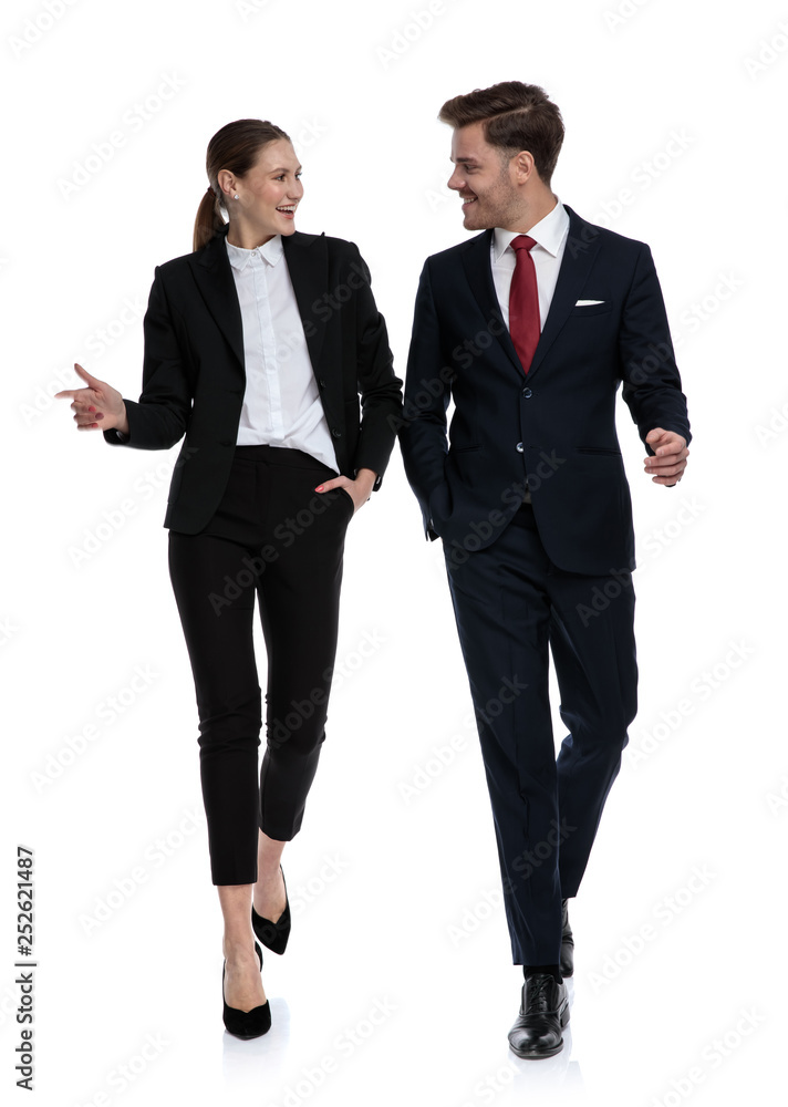 couple in business suits walking and talking couple in business suits walking and talking