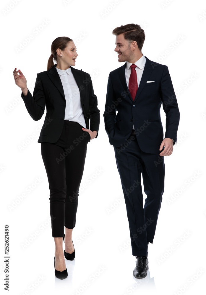 couple in business suits walking and talking couple in business suits walking and talking