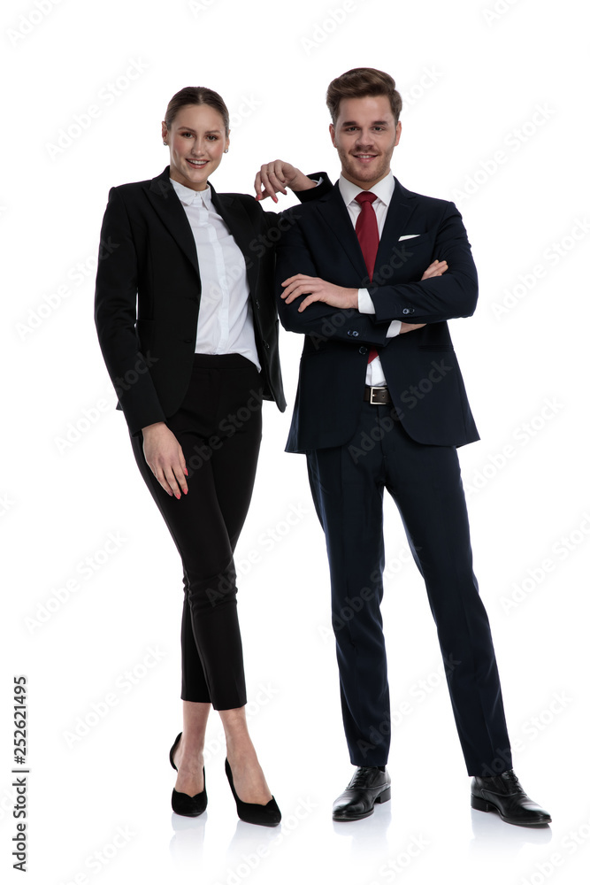 couple in business suits standing with elbow lean on shoulder couple in business suits standing with elbow lean on shoulder
