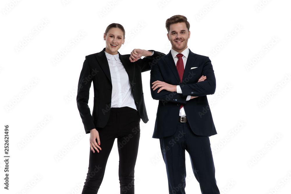 couple in business suits standing with elbow lean on shoulder couple in business suits standing with elbow lean on shoulder