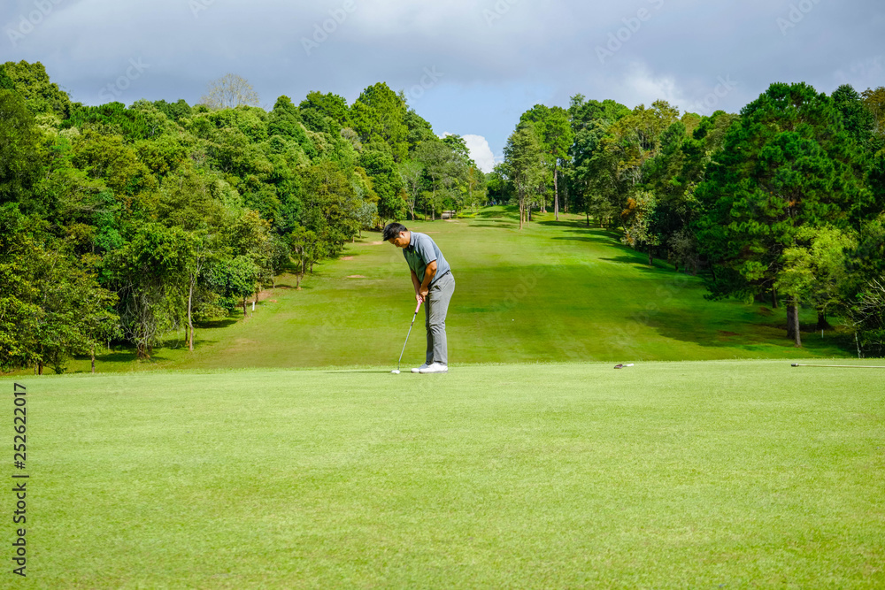 Golfer playing golf in beautiful golf course in the evening golf course with sunshine in thailand