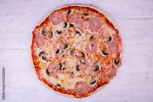 Ham and mushrooms pizza under cheese