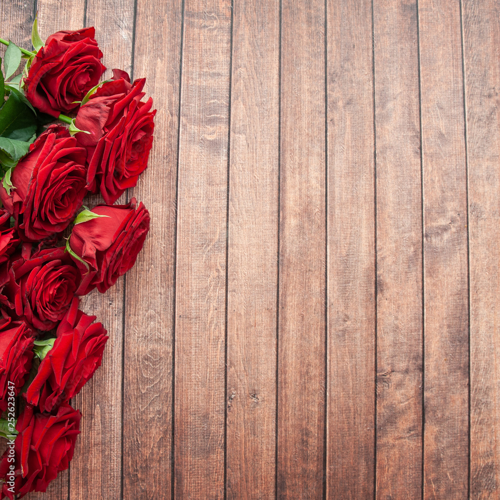 Bouquet of roses on a wooden background, space for text Bouquet of roses on a wooden background, space for text