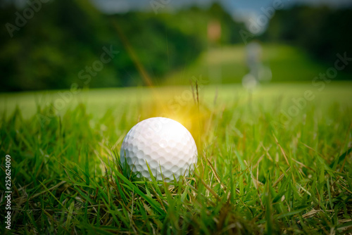 Blurred Golf ball on green in beautiful golf course at sunset background. Golf ball on green in golf course at Thailand