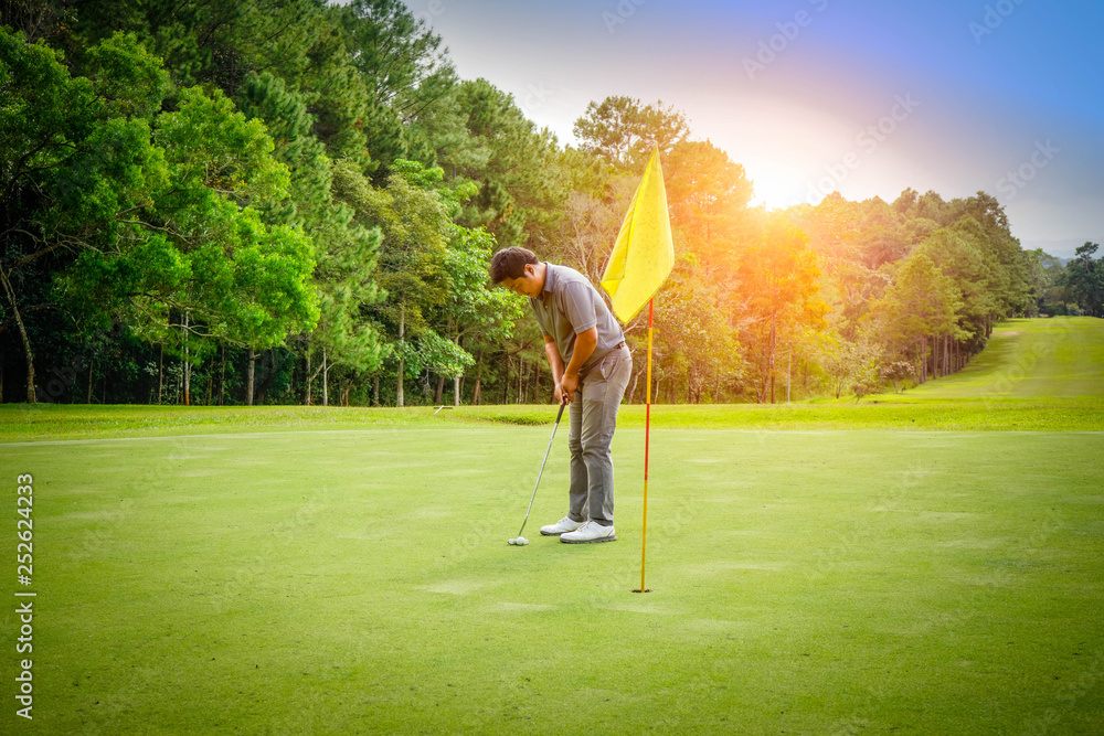 Golfer playing golf in beautiful golf course in the evening golf course with sunshine in thailand