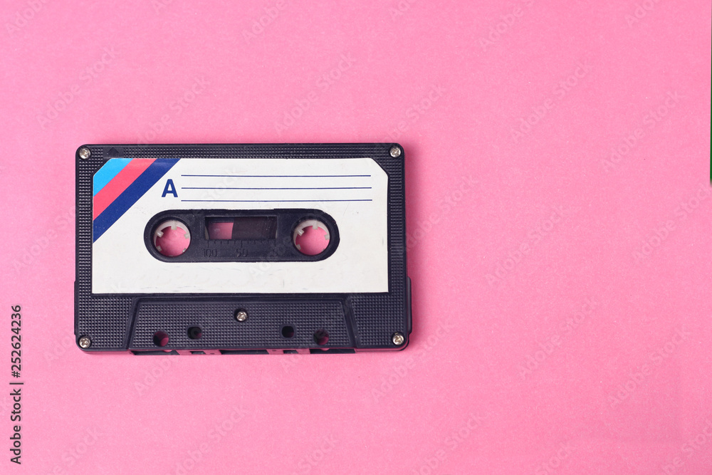 Audio retro vintage cassette tape 80s style on pink background