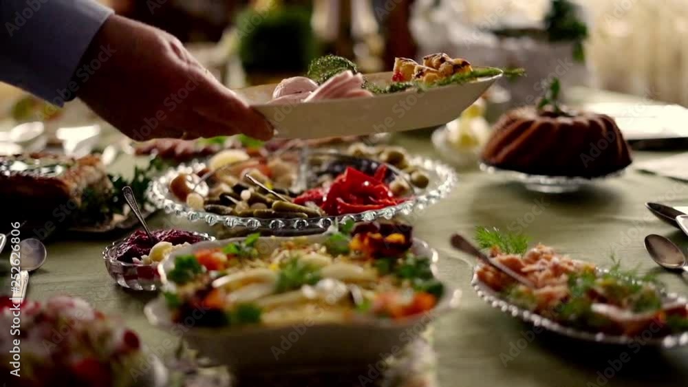 Hand putting platter with ham on table, super slow motion Hand putting platter with ham on table, super slow motion