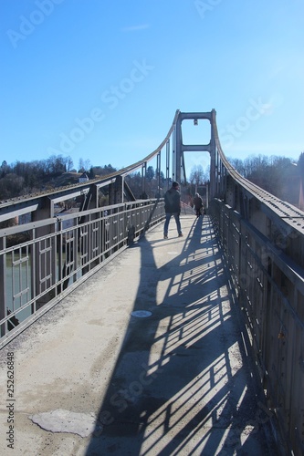 The pedestrian steel bridge Innsteg or Fünferlsteg in Passau, Germany. Erected in 1916. It connects the old town of Passau and the district Innstadt, in February. Europe. photo