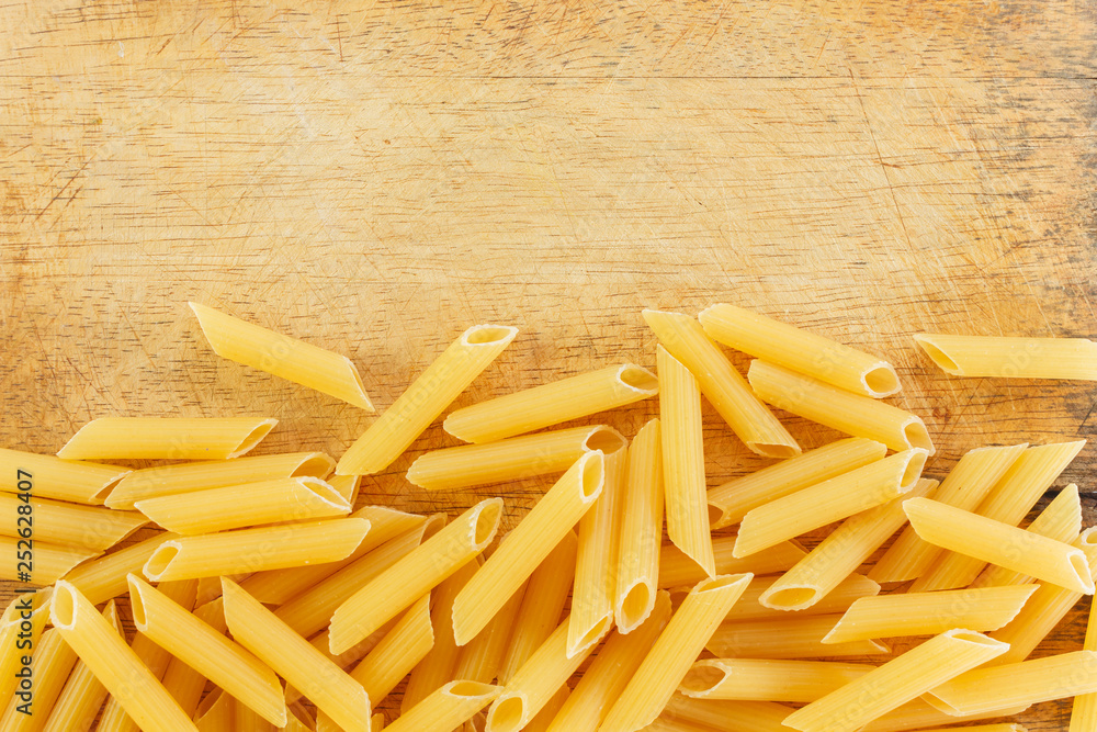 dry pasta penne Italian food wooden. dry pasta penne Italian food wooden.