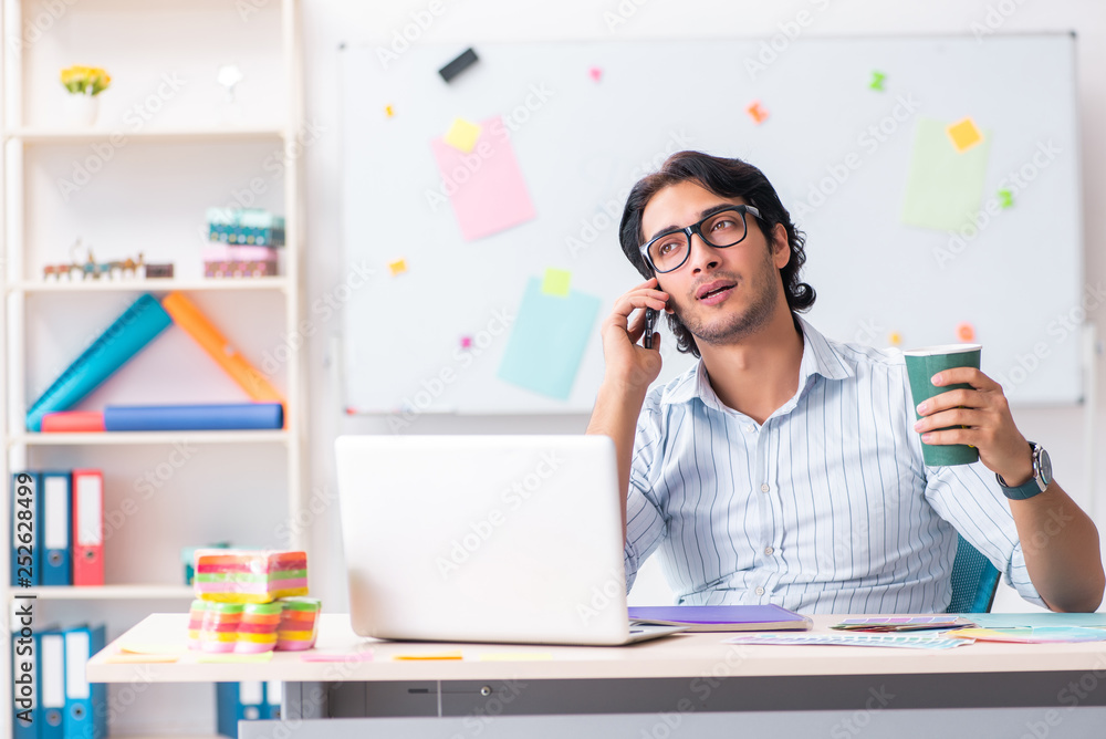 Young handsome male designer working in the office Young handsome male designer working in the office
