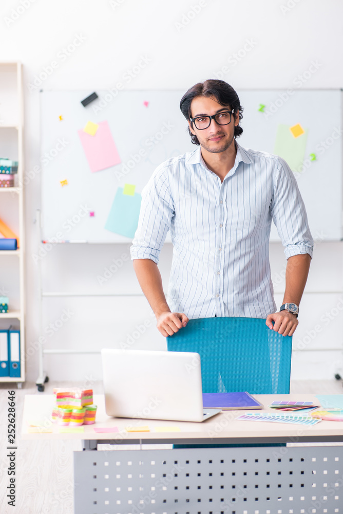Young handsome male designer working in the office Young handsome male designer working in the office