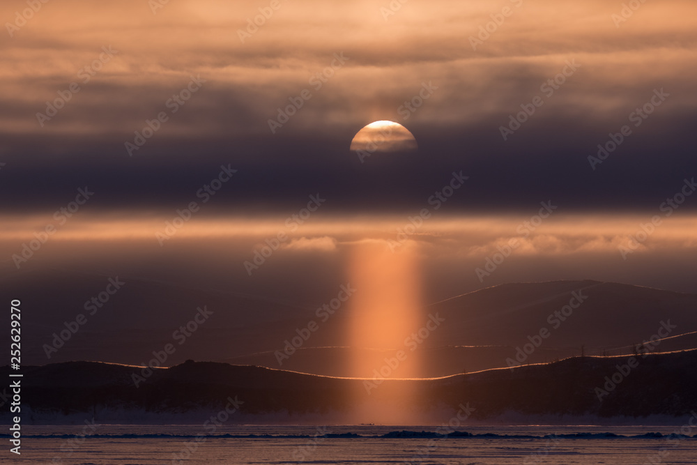 Sun pillar at dawn on Lake Baikal Sun pillar at dawn on Lake Baikal