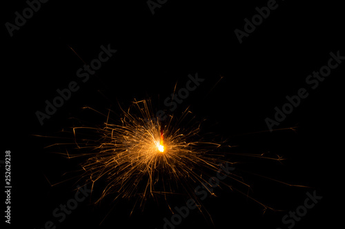 Bengal fire. New year sparkler candle on black background